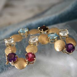 Geelgouden schijfjes armband