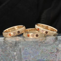 Drie ringen met edelstenen, hessoniet, champagnekleurige diamant en rookkwarts.