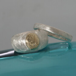 Goud en zilveren trouwringen, met in de damesring het familiewapen Regt door zee